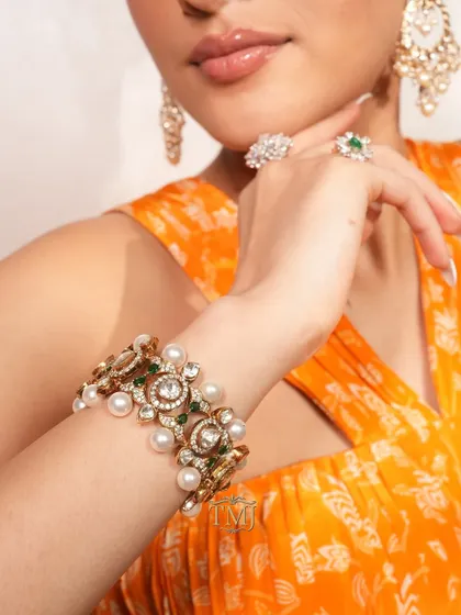 In frame: a stunning polki and pearl bracelet that doubles up as a choker, paired with pearl chandbalis and diamond rings for a complete festive look.