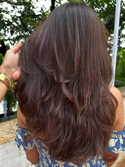 Another angle showing the seamless layers and the healthy shine of her hair after the service.