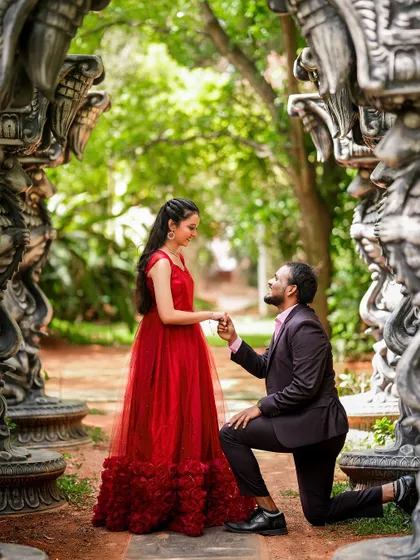 A romantic proposal shot framed by intricate stone carvings, adding a sense of grandeur and history.