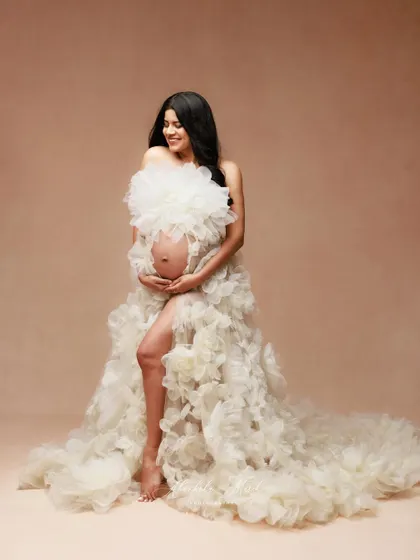 A joyful and candid moment in the beautiful white floral gown, showing off its unique texture and playful spirit.