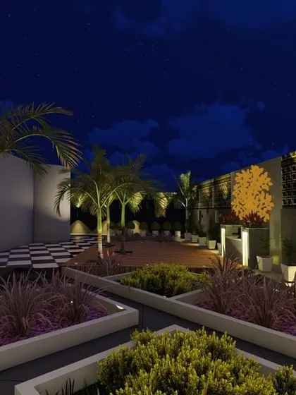 A night view of a terrace with geometric planters and a beautifully lit feature wall. The strategic use of uplighting and backlighting creates a sophisticated and modern aesthetic.