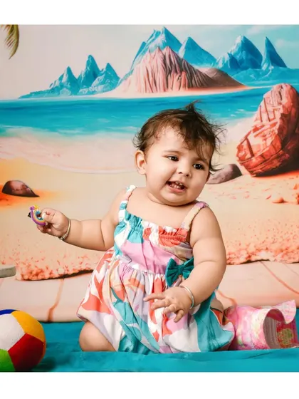 A day at the beach, right in the studio. This fun and colorful beach-themed backdrop is a creative way to capture a vacation vibe.