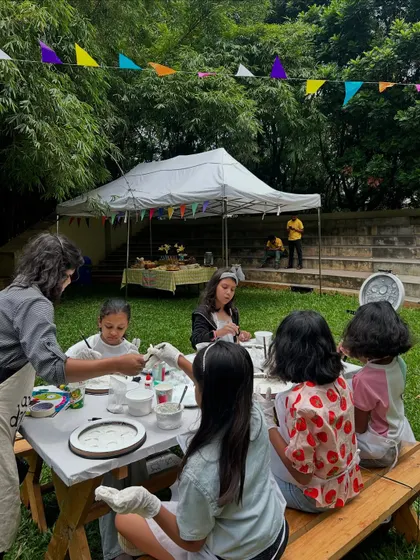 Here I am guiding a group of young artists through the moon lamp making process at an outdoor party. We provide everything needed, including aprons and gloves, for a fun and mess-free experience.