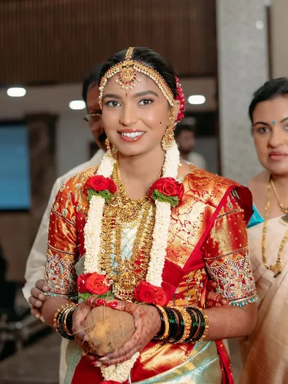 A candid moment as the bride enters the ceremony. Her makeup is fresh and radiant, capturing her happy and excited expression perfectly.