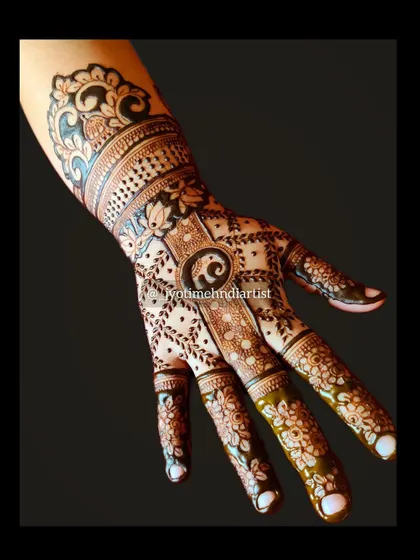 A creative back-of-hand design featuring a baby elephant, floral elements, and paisley patterns for a unique and traditional look.