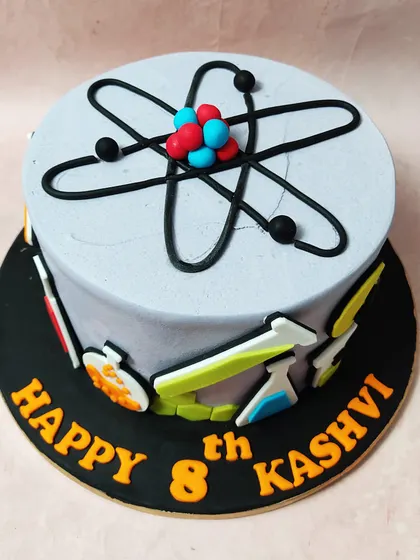 A cake for the curious mind, this Science Cake is topped with an atom and decorated with beakers, flasks, and lightbulbs.