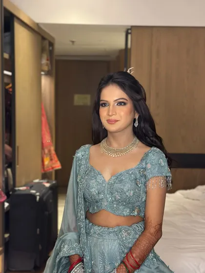 The bride-to-be, looking radiant with her half-up hairstyle for her engagement ceremony.