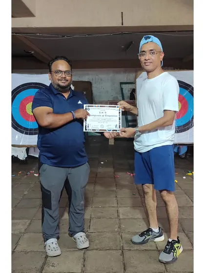 This student receives his certificate after successfully completing the basic archery course.