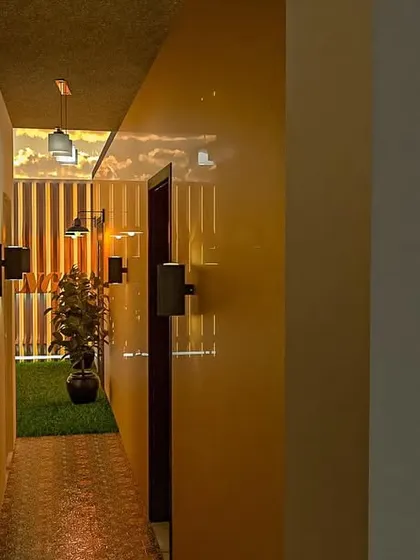 A view down a corridor in our marriage hall design. We use strategic lighting, planters, and wall textures to ensure that even transitional spaces are elegant and well-designed.