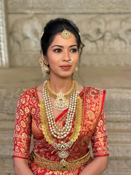 Lipika's side profile, highlighting the classic nose pin and the soft yet striking makeup that enhances her natural beauty.