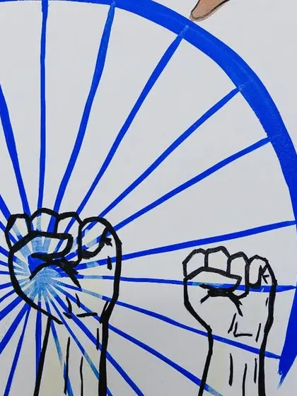 The Ashoka Chakra with fists of protest, symbolizing the fight for rights and justice. This detail is a core part of the mural's message.