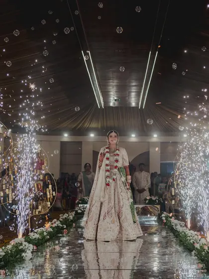 The bride's grand entrance down a mirrored aisle. I lined the walkway with cold pyro fountains that erupted as she walked, creating a dazzling and dramatic path to her groom.