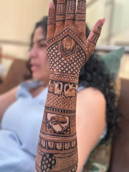 This design includes a portrait of a deity, showcasing my ability to create detailed and respectful religious figures in mehndi.