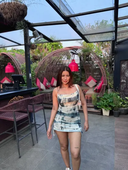 Walking towards the camera in the tie-dye dress.
