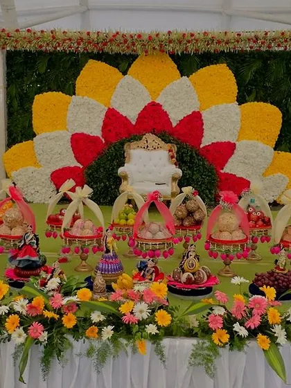 Another view of the colorful outdoor gift platter display. This wide shot shows how the entire arrangement, including the large dolls, creates an impressive and welcoming entrance for guests.