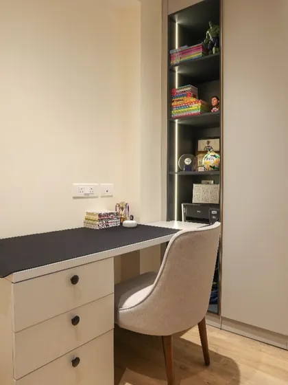 We designed this compact unit for a teen's room, combining a study desk with drawers and an adjoining storage unit with open, lit shelves and closed cabinets.