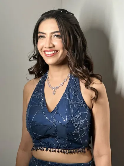 A candid shot of pure happiness. The makeup is designed to be both glamorous and durable, ensuring she looks perfect throughout her sangeet night.