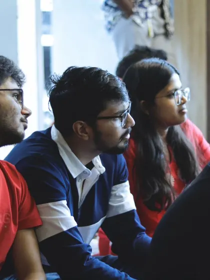 Participants in a workshop, listening intently. We foster a focused and respectful learning environment where everyone feels comfortable to participate.