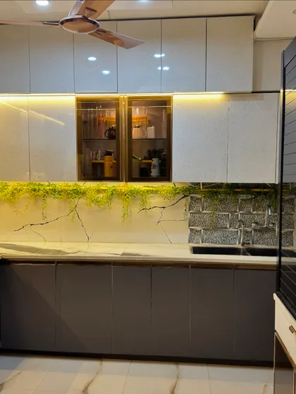 This angle highlights the glass display cabinets and the seamless integration of the chimney hood, creating a clean and organized look.