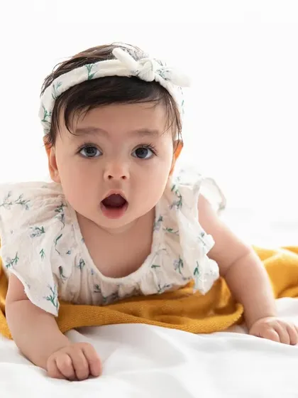 A look of pure wonder. This close-up captures the beautiful, wide-eyed curiosity of a baby exploring the world.