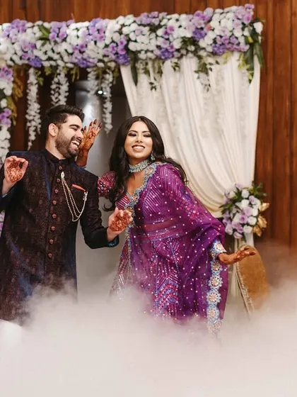 The couple takes center stage for their sangeet dance, surrounded by smoke for a dramatic and magical effect.