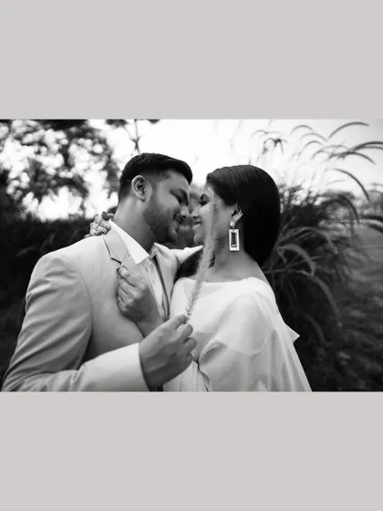 A romantic black and white close-up of the couple, their faces close, sharing an intimate moment.