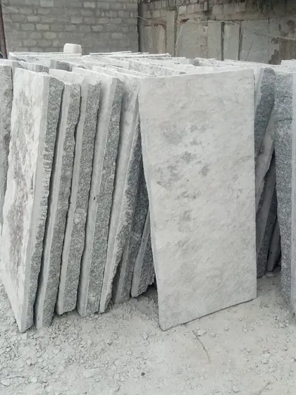 A stack of large, rectangular Narasapura stone slabs, ideal for creating impressive walkways.