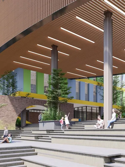 The central amphitheater at Basil School, designed as the social heart of the institution. This multi-level space under a large canopy is perfect for assemblies, performances, and informal student gatherings.