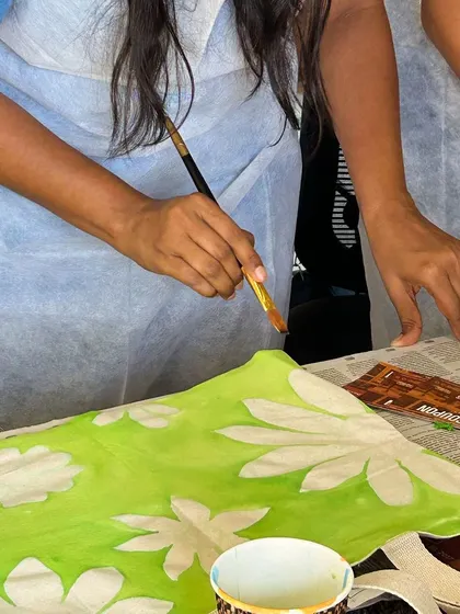 A close-up of a tote bag being painted with a floral design. The process is just as enjoyable as the final product.
