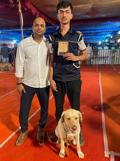 Posing with a trophy at the Karavali Dog Show.