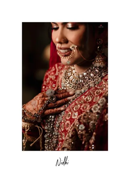 A close-up portrait of the bride, highlighting her intricate nose ring and the beautiful details of her wedding jewelry.
