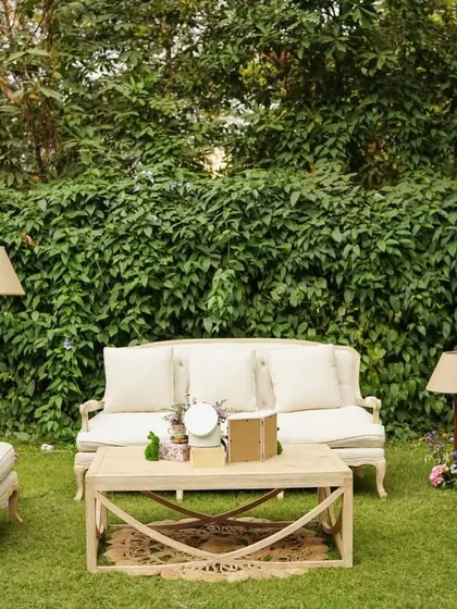Another angle of the chic outdoor lounge, complete with classic furniture and floor lamps for a cozy, living-room feel.