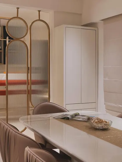 The dining area with the pooja unit doors closed, creating a clean and seamless wall surface.