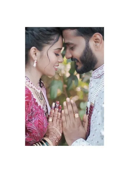 A creative and symbolic pose with the couple's hands together, showcasing their bond and their engagement rings.