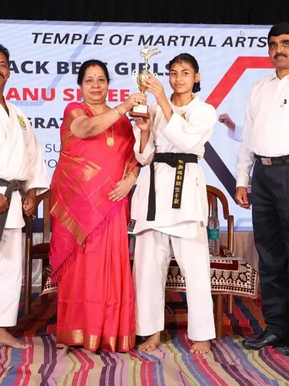 We recognize excellence at every level. Here, one of our top-performing female students is awarded for her outstanding performance in the black belt examination.