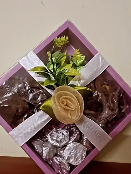 Another angle of the 'Crunchy Munchy Box', showcasing the assortment of different chocolate treats inside, all visible through the clear window.