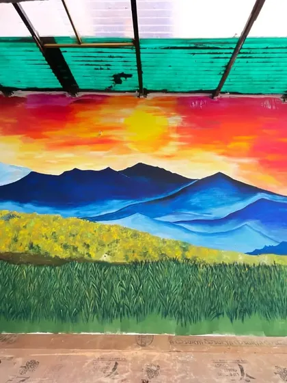 A straight-on view of the sunset landscape mural. The scale of the piece allows you to feel like you are really standing in that field, watching the sun go down.