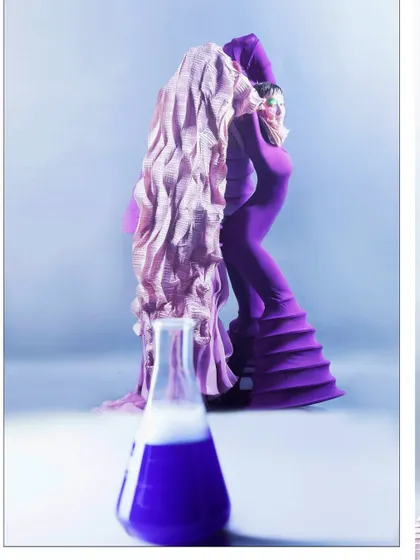 The model is posed behind a scientific beaker filled with a fuming purple liquid, her own purple outfit echoing the color. This shot directly links the fashion narrative to the scientific concept of a 'Chemical Reaction'.