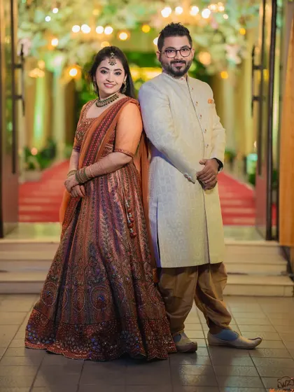 A stylish, full-length portrait of Rohan and Pooja. The back-to-back pose is modern and confident, showcasing their individual style.