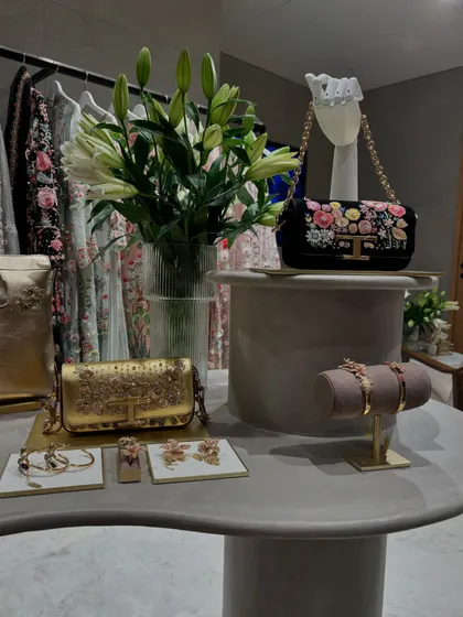 A detail shot from a store visit, showcasing a collection of intricately embroidered bags and matching jewelry. This is how I find the perfect finishing touches for a client's look.