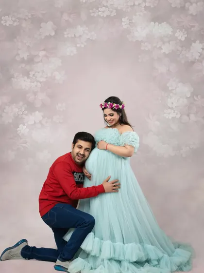 The dad-to-be listens in, sharing a special moment with his baby. This is a classic and heartwarming pose for any maternity couple photography session, full of love and wonder.