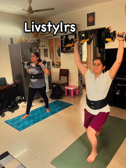 Two clients perform lunges with an overhead press, a compound exercise that provides a full-body workout, improving strength and coordination.