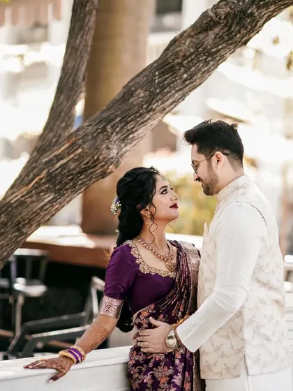 A romantic portrait of the couple, with the groom looking lovingly at his bride. Her makeup is classic and elegant.