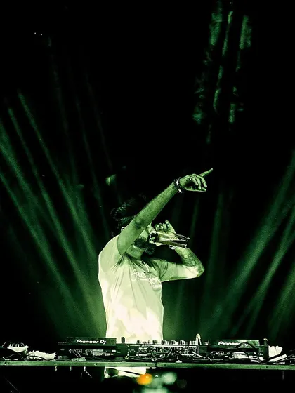 Pointing to the crowd under green spotlights. It's a simple gesture, but it's how I connect with people and make them feel part of the show.