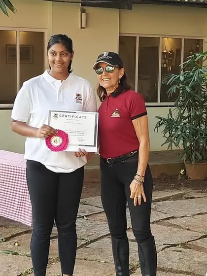 A smiling camper proudly holds her certificate at the conclusion of our Summer Camp. It's a wonderful memento of a week filled with learning and fun.