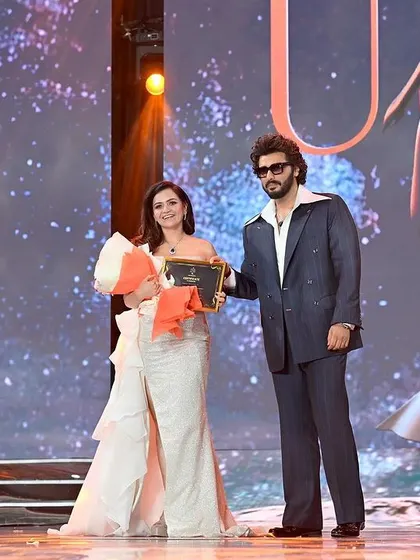 A celebrity judge presenting an award at a beauty pageant. Capturing these moments adds to the prestige of the event portfolio.