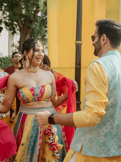 The bride and groom sharing a dance, their smiles lighting up the celebration.