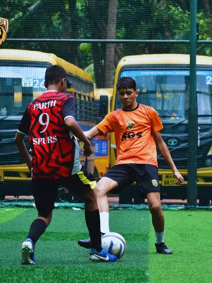 An intense one-on-one duel during a match, with our player determined to win the ball.