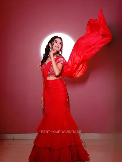 A dramatic shot of the red ruffle saree with the pallu in motion, capturing its energy and flair.