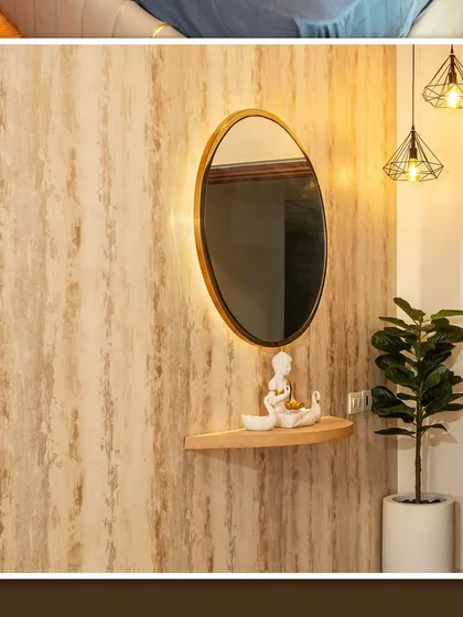 The foyer of the Brigade Cornerstone Utopia apartment, with a textured wallpaper and an elegant backlit mirror.
